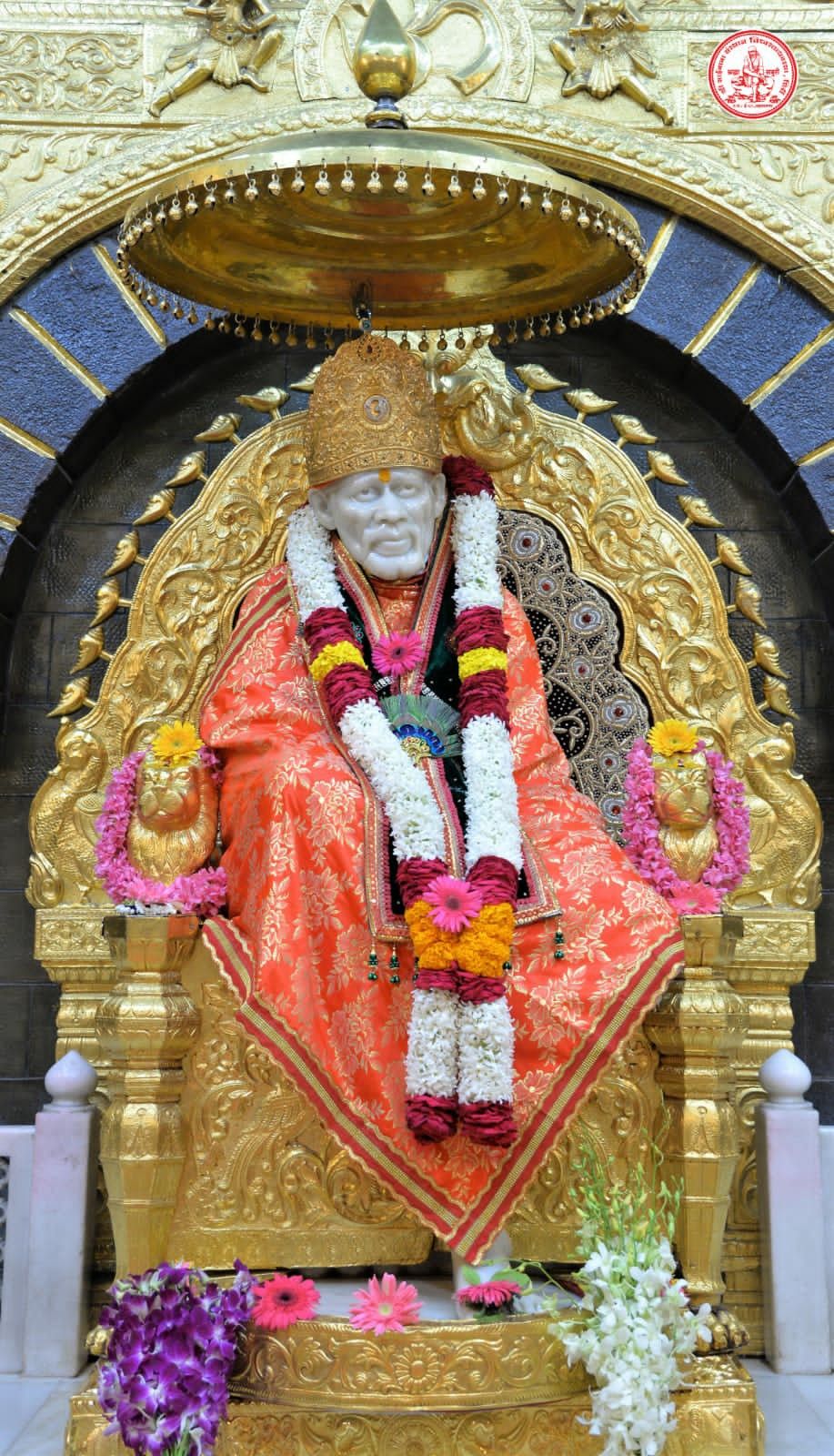Sai Baba seated on golden throne