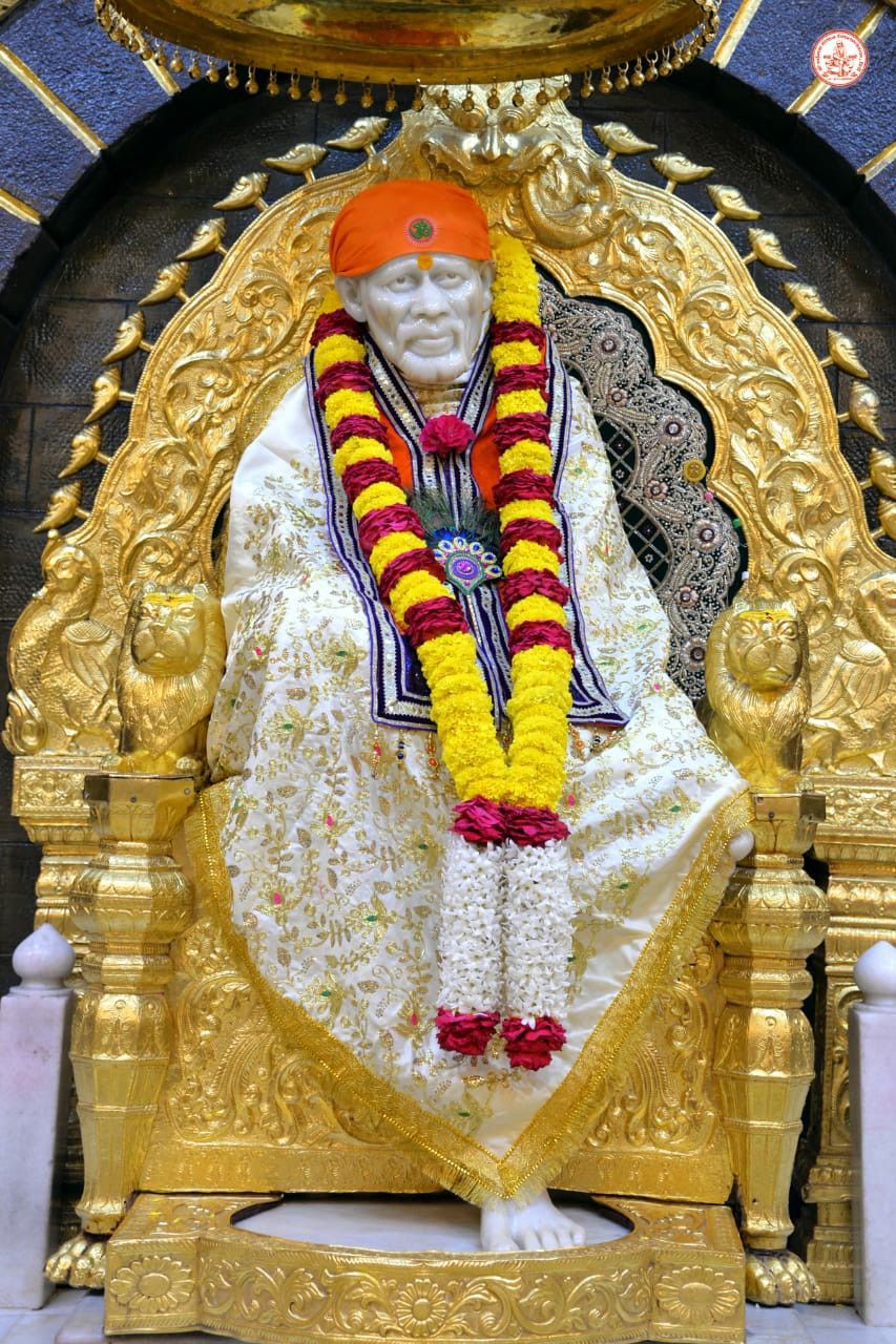 Sai Baba seated on golden throne.