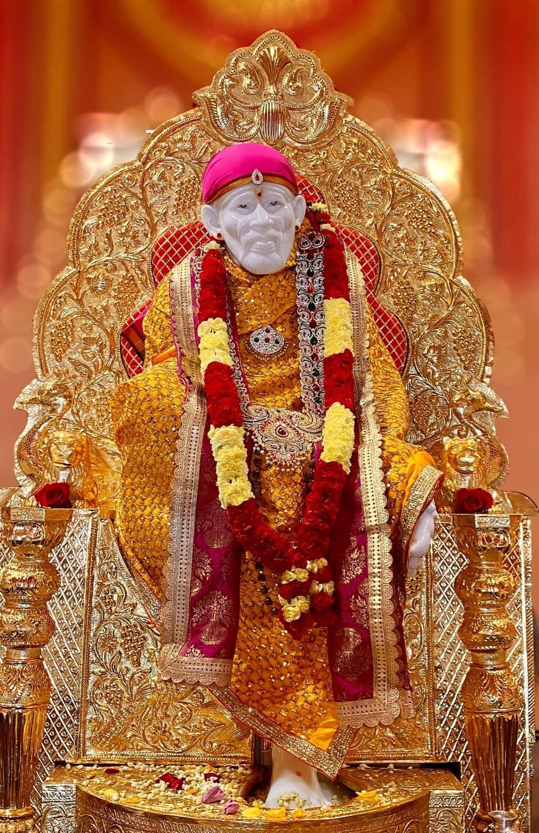 Sai Baba seated on golden throne