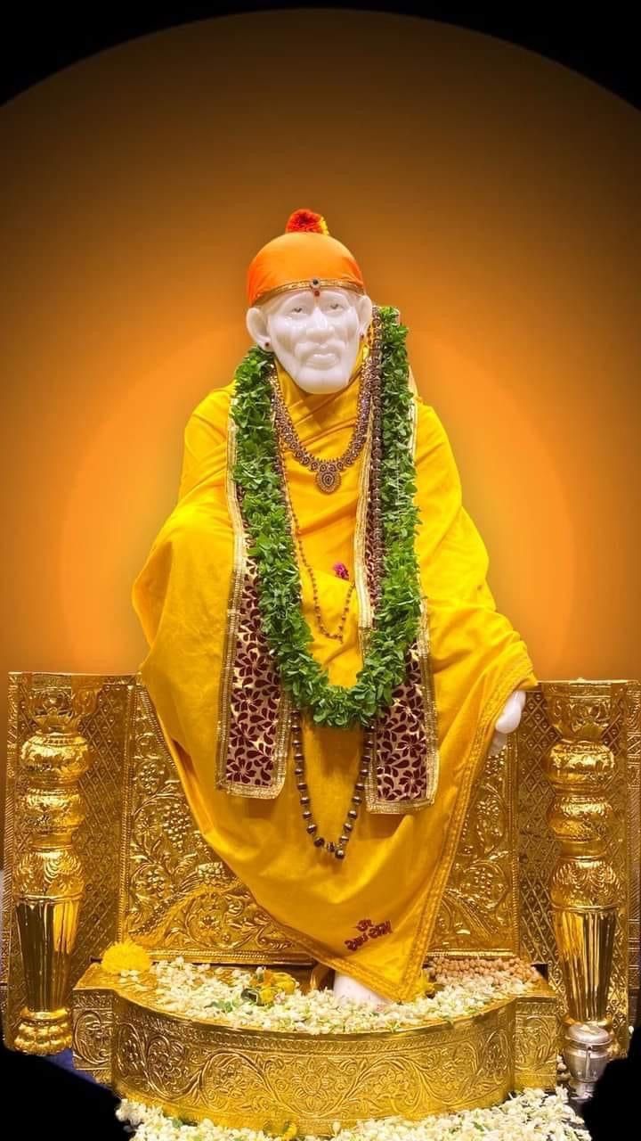 Sai Baba in golden yellow robes