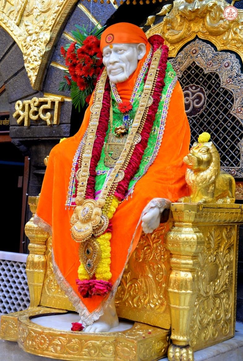 Sai Baba seated on a golden throne