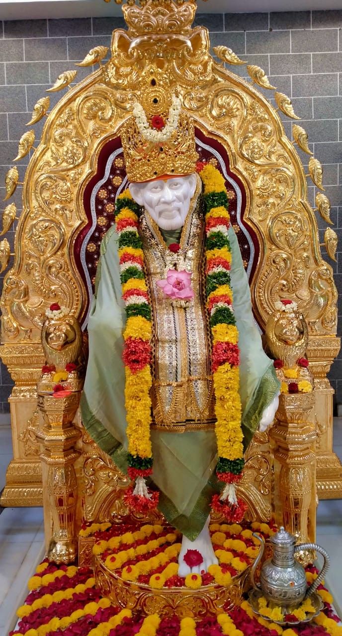 Sai Baba seated on golden throne