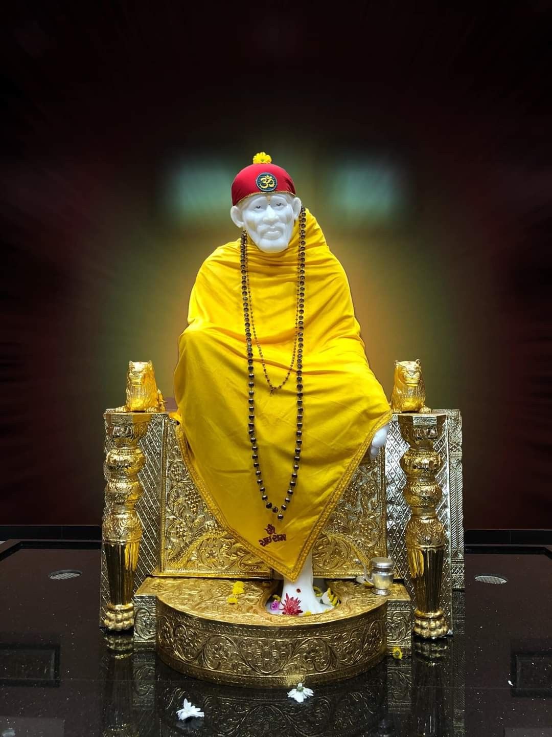 Sai Baba seated in golden chair
