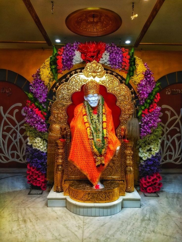 Sai Baba in ornate gold throne