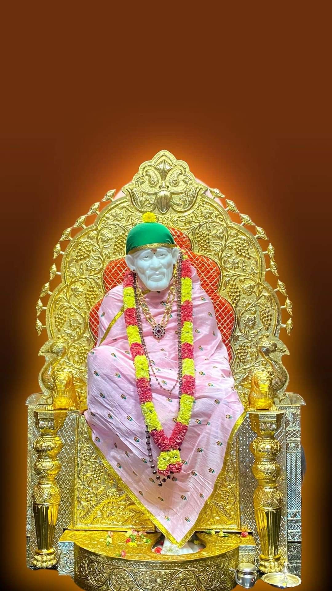 Sai Baba seated on golden throne