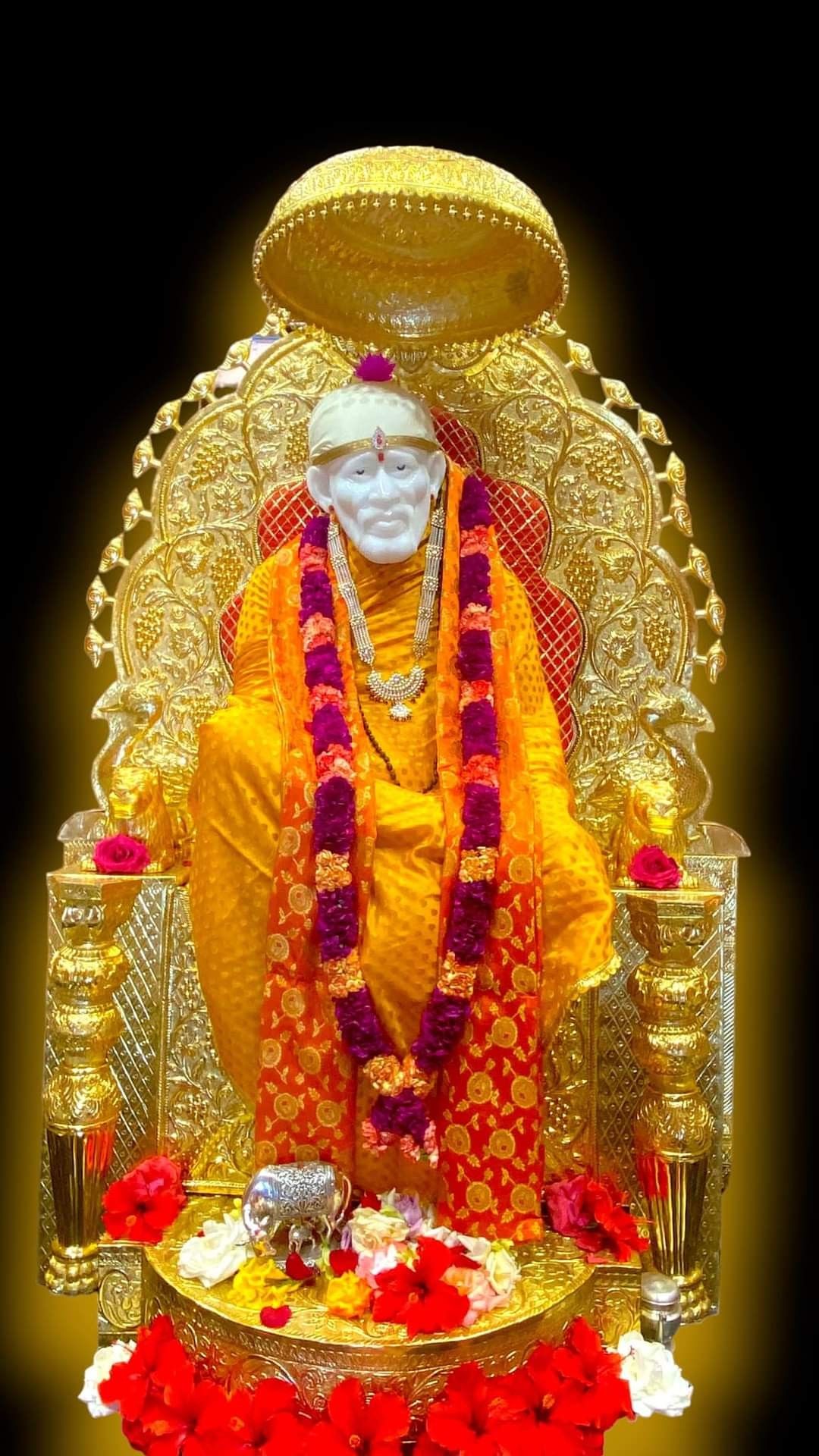Sai Baba seated on golden throne