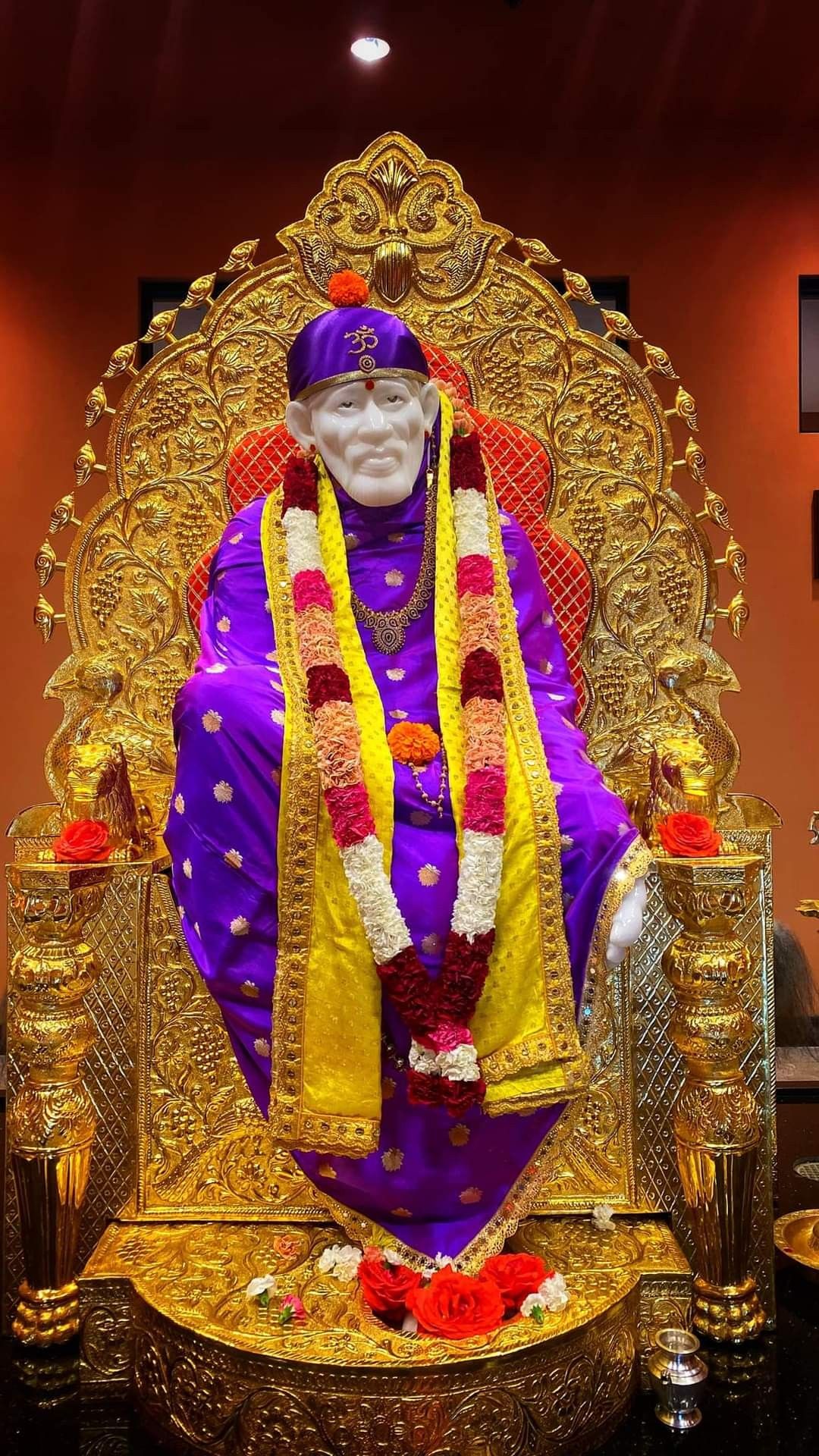 Sai Baba seated on golden throne