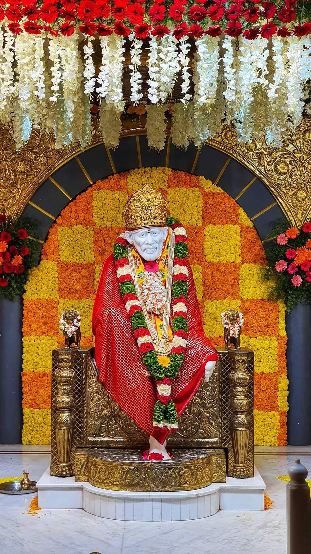 Sai Baba amidst vibrant marigold flowers
