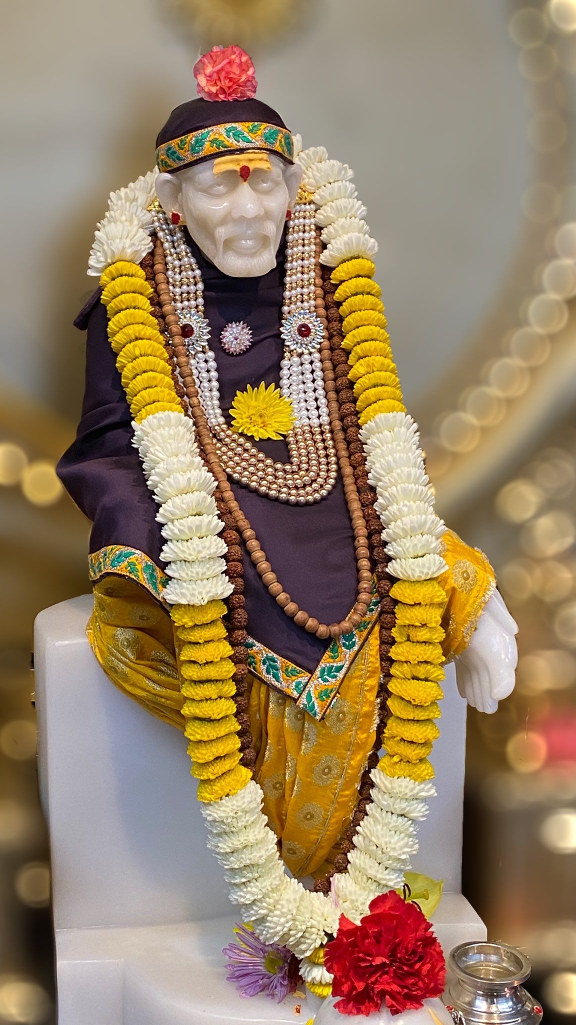 Sai Baba with floral garland statue