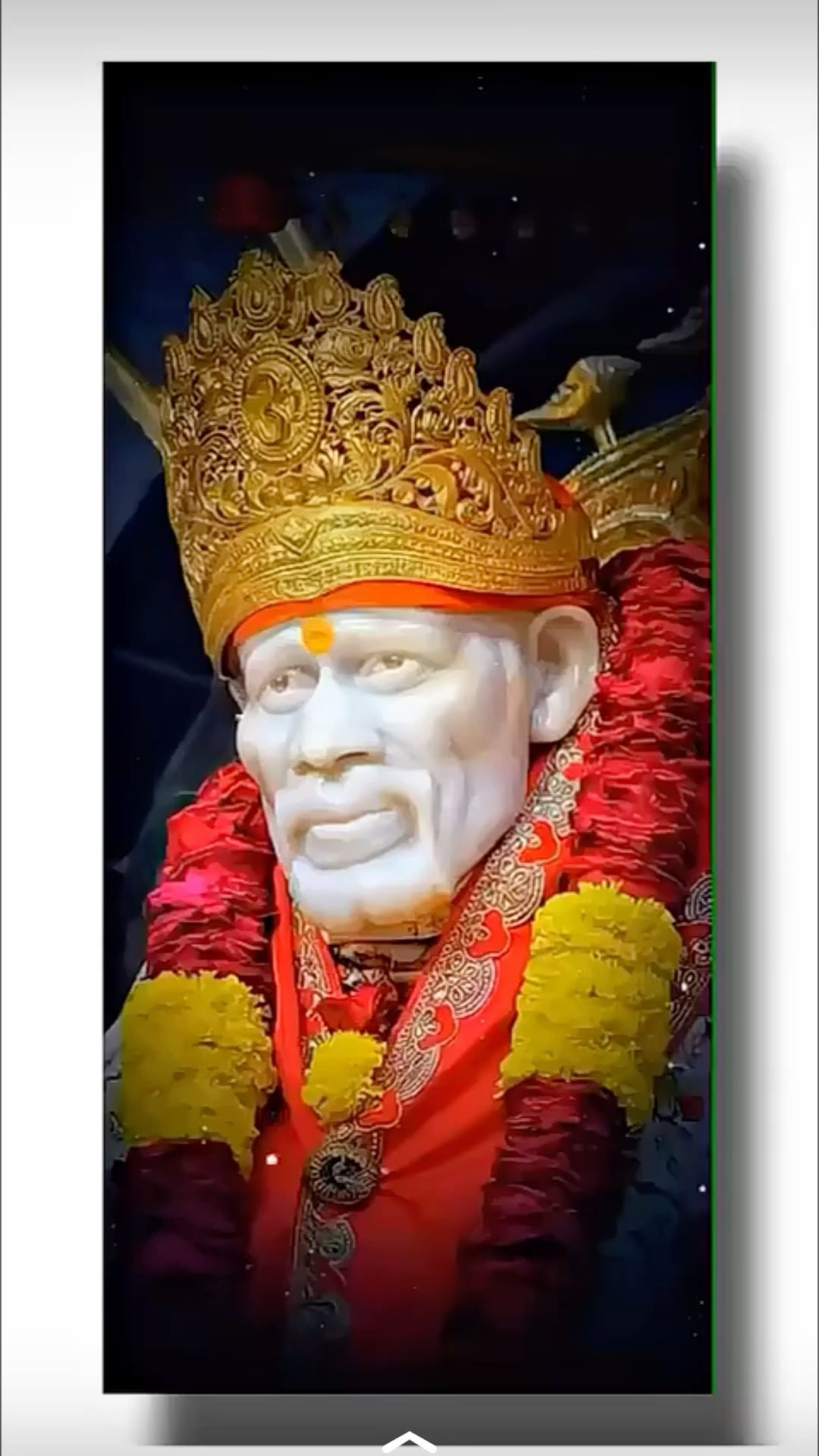 Sai Baba with golden crown and garland