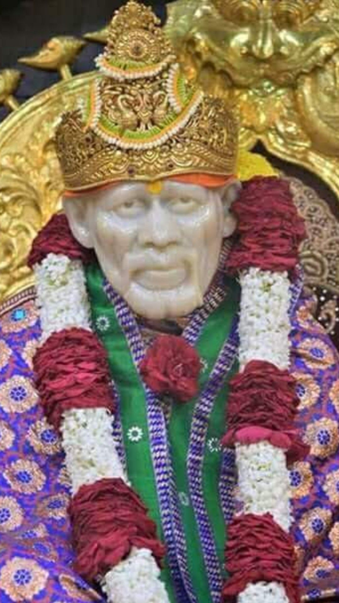 Sai Baba with floral garland and crown
