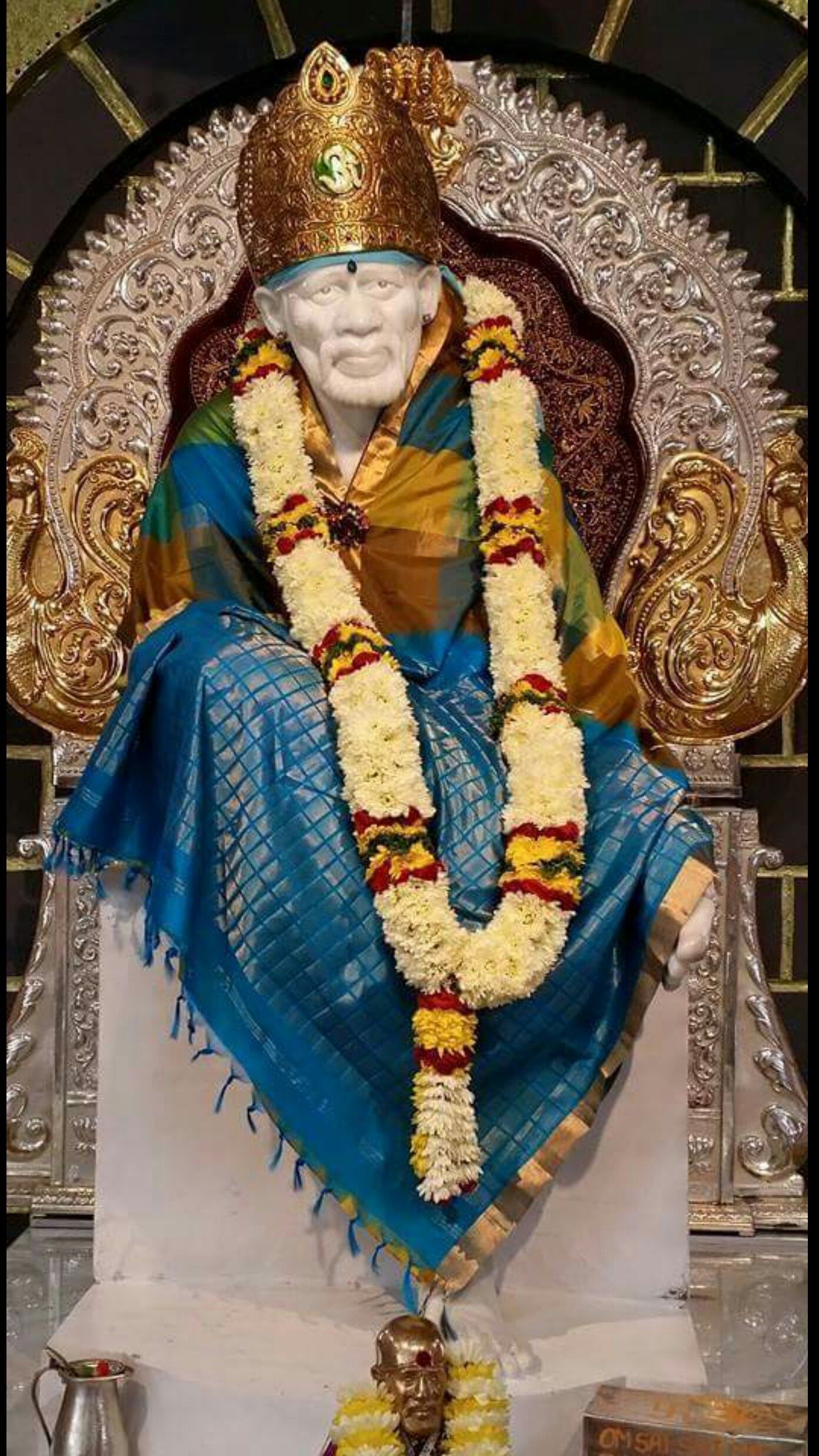 Sai Baba idol adorned with flowers