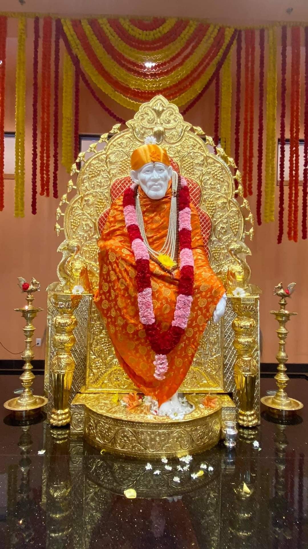 Sai Baba seated on golden throne