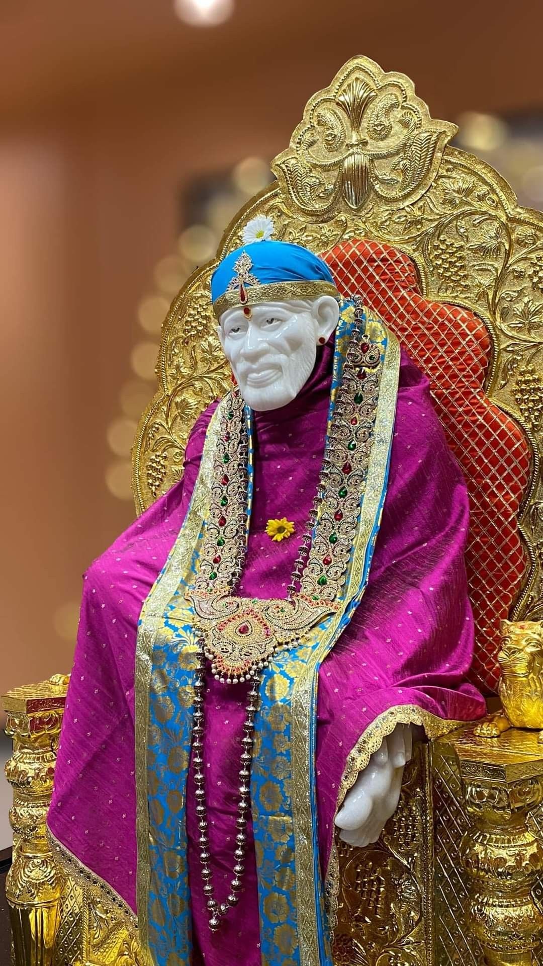Sai Baba seated on a golden throne