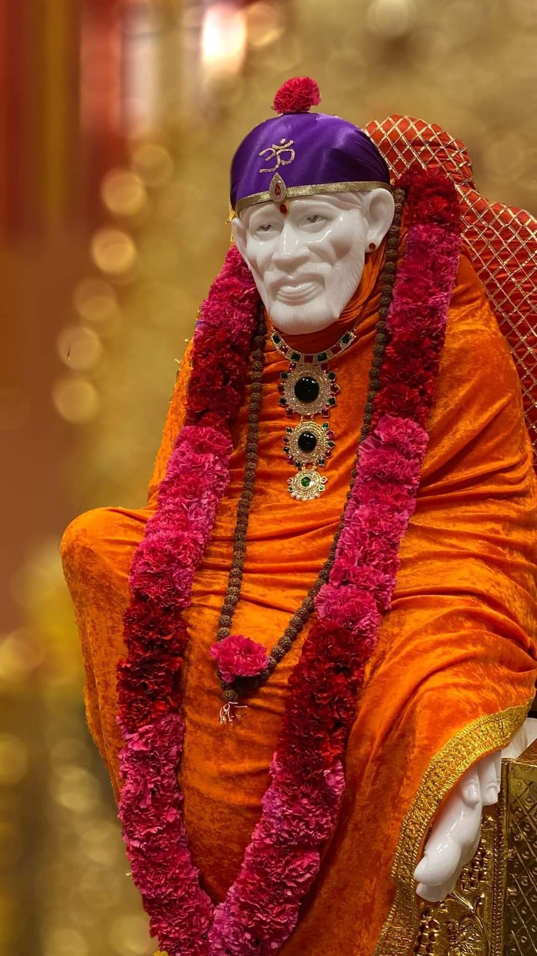 Sai Baba idol with orange robes