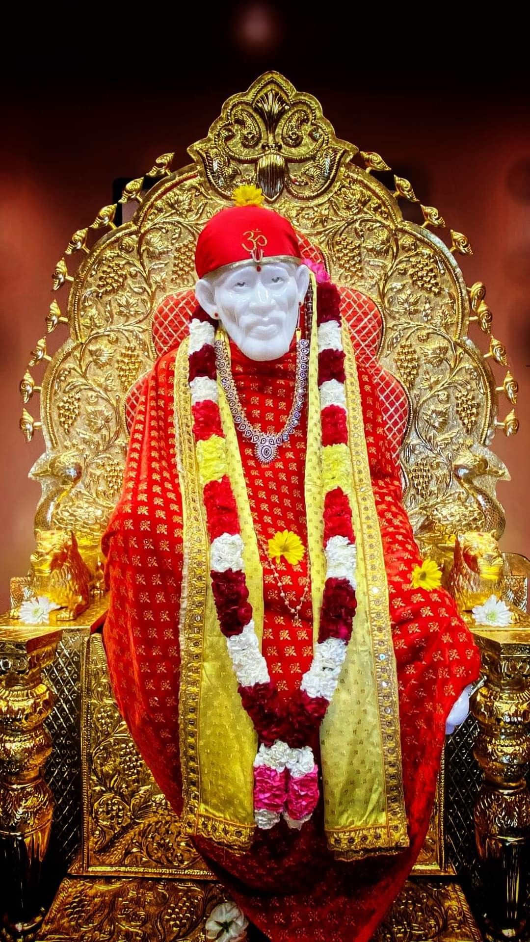 Sai Baba seated on golden throne