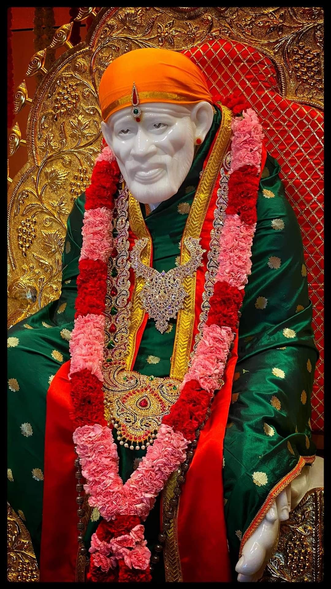 Sai Baba idol with floral garland