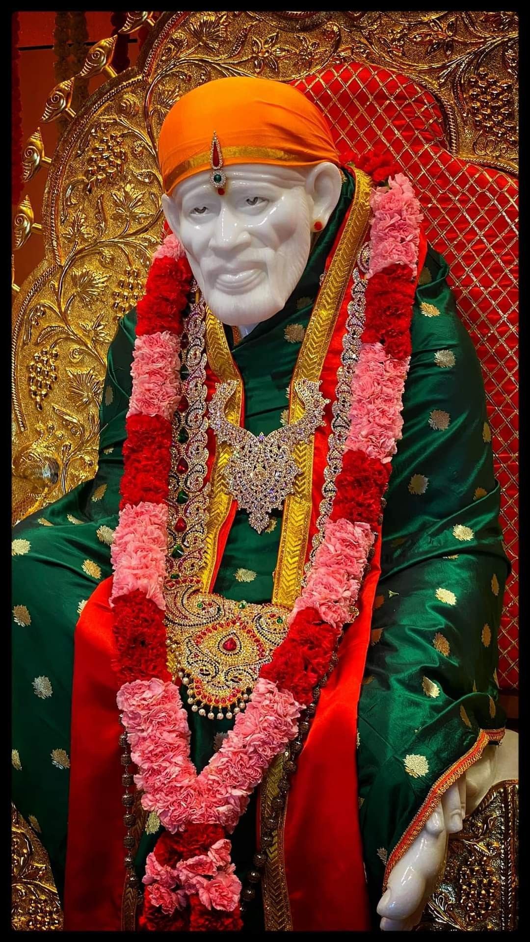 Sai Baba statue with floral decorations