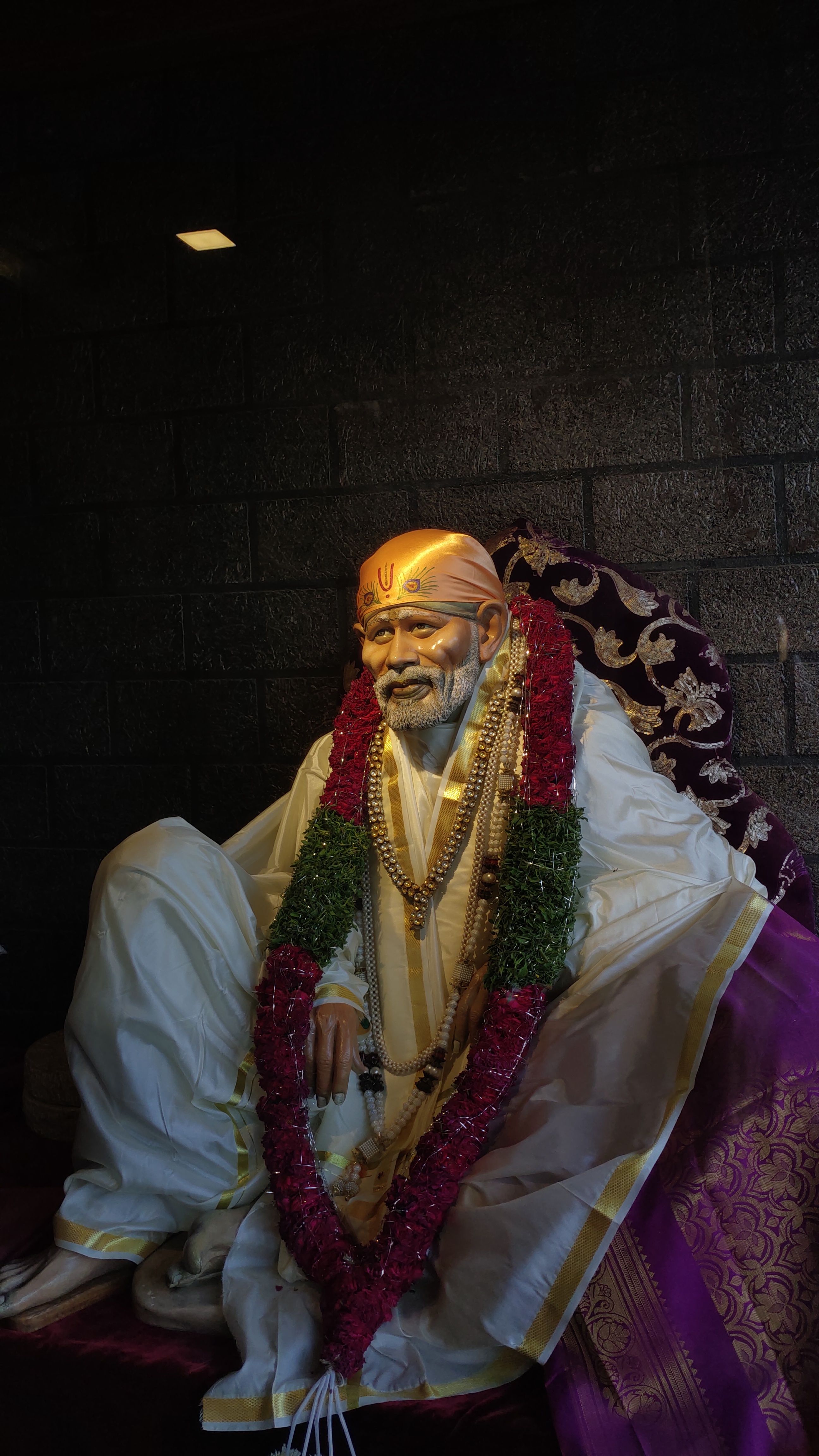 Sai Baba seated in peaceful contemplation