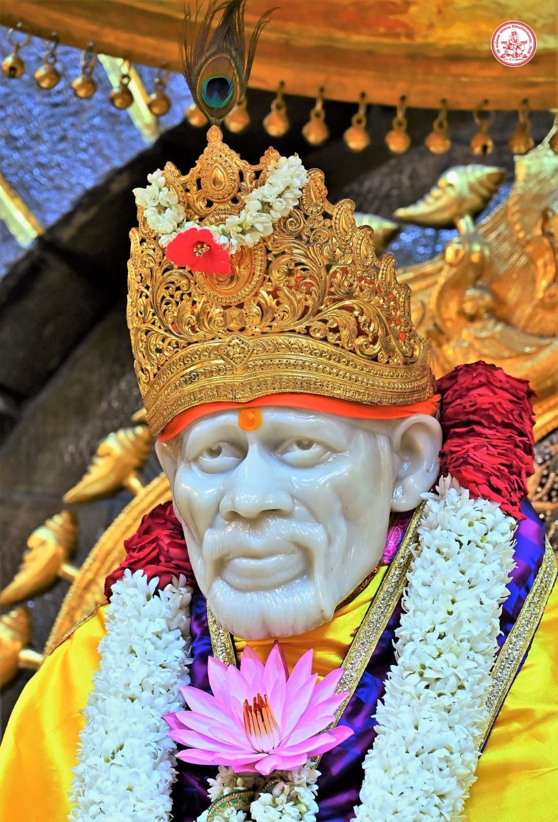 Sai Baba with floral crown and lotus