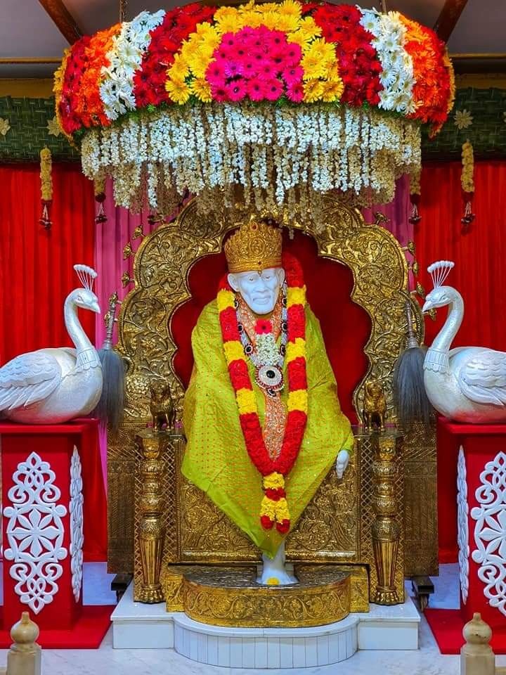 Sai Baba on floral throne