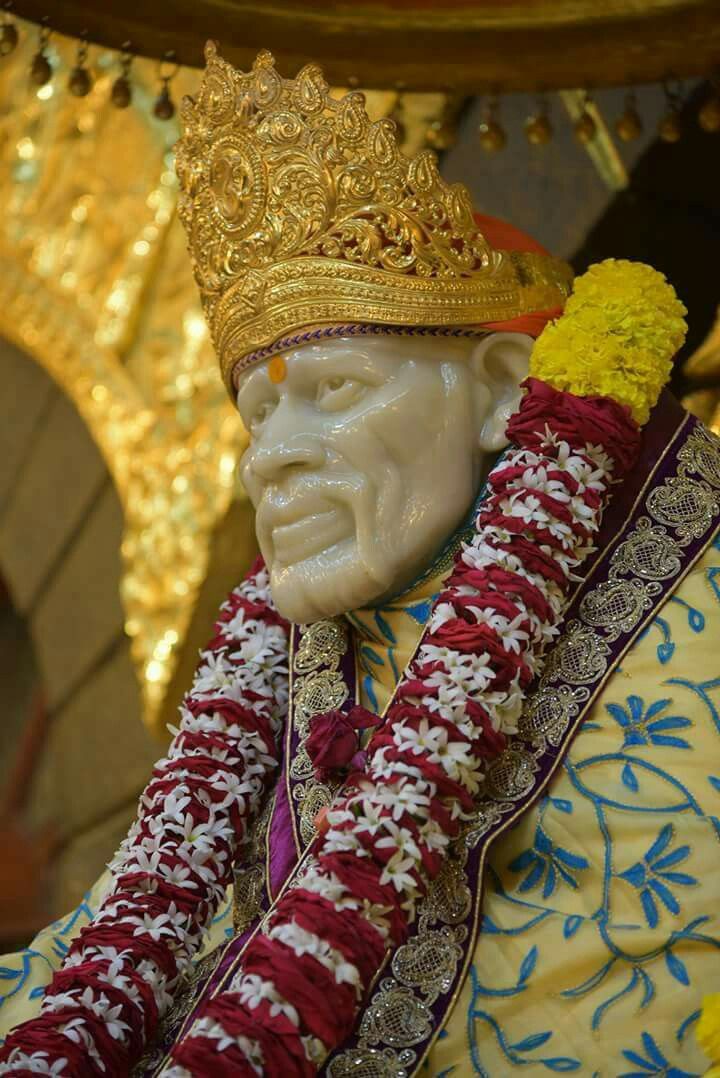 Sai Baba with golden crown, peaceful image.