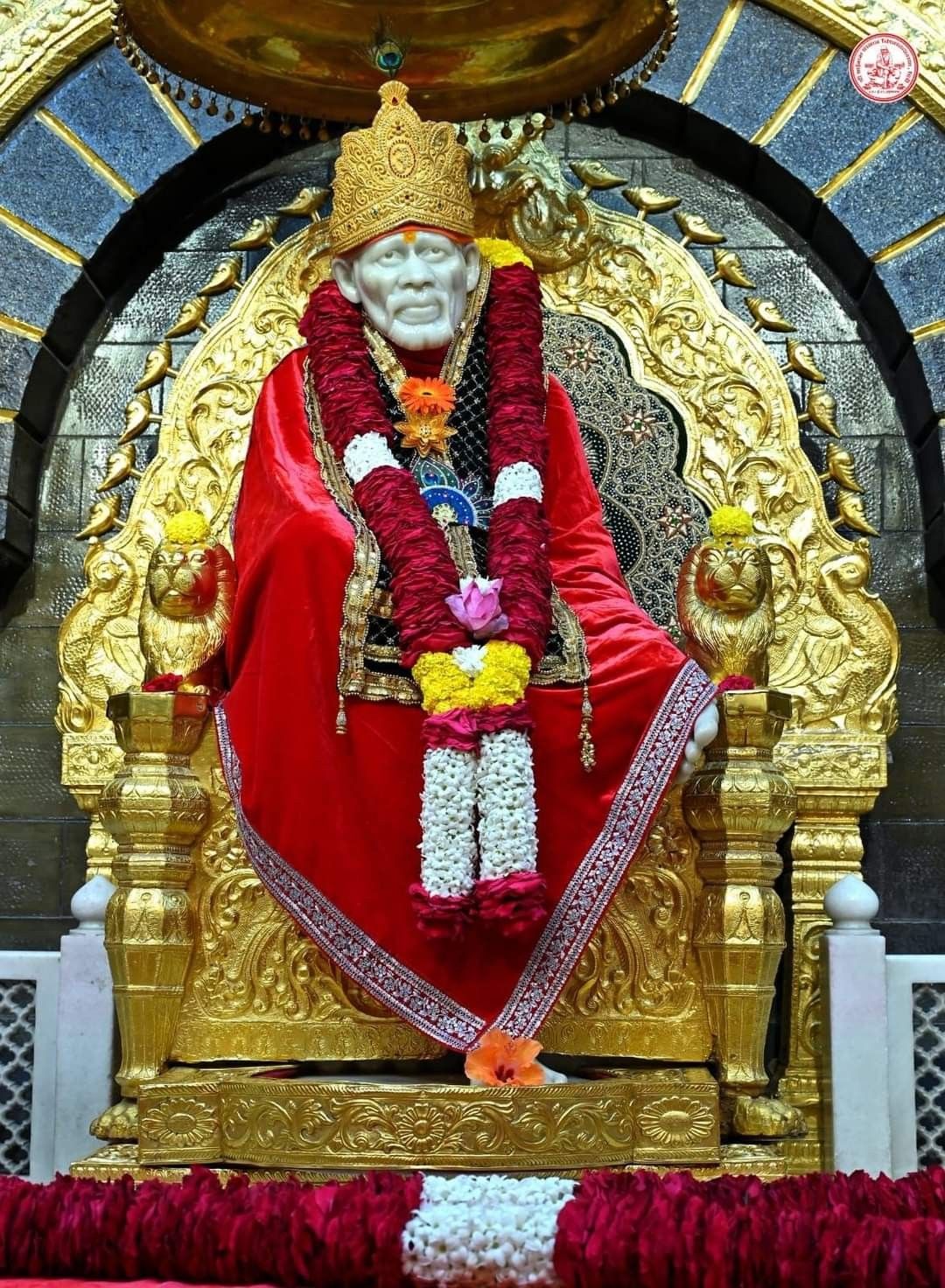Sai Baba seated on golden throne
