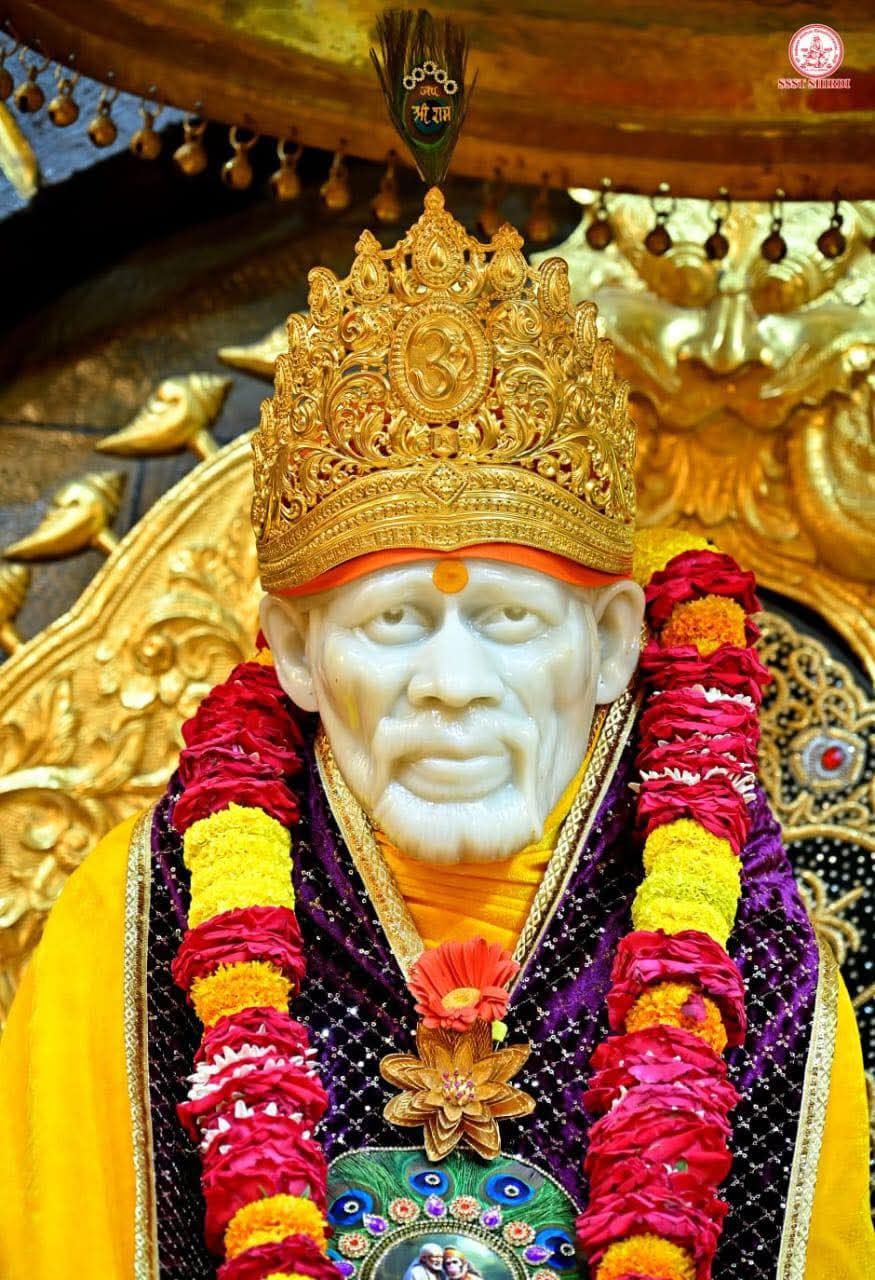 Sai Baba adorned with golden flowers