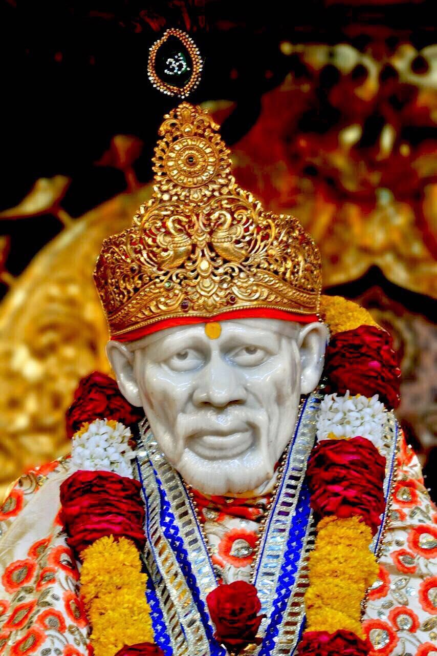 Sai Baba with golden crown and flowers