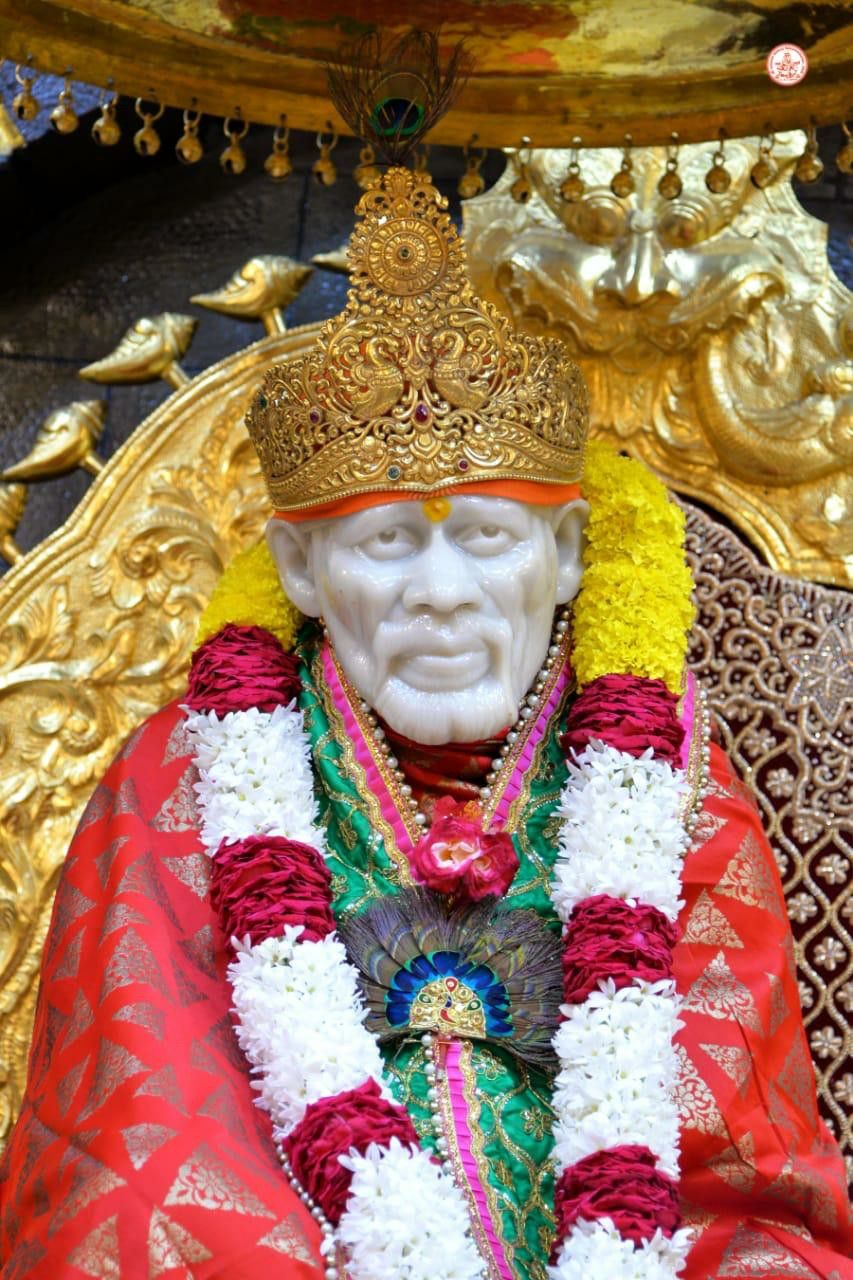 Sai Baba adorned in golden crown