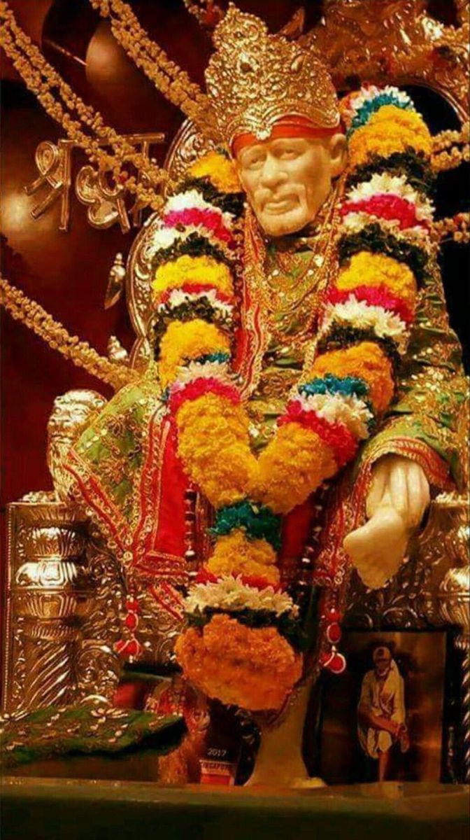 Sai Baba seated on a golden throne