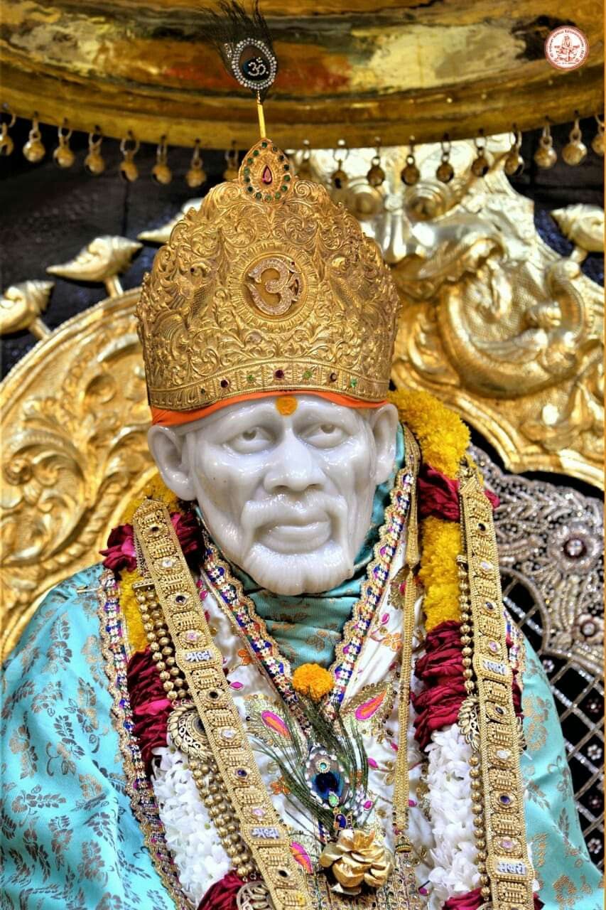 Sai Baba with ornate golden headgear