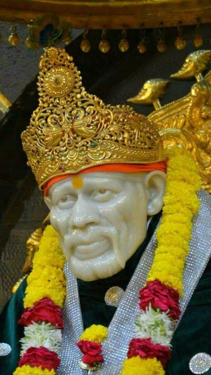 Sai Baba with golden crown and garland.