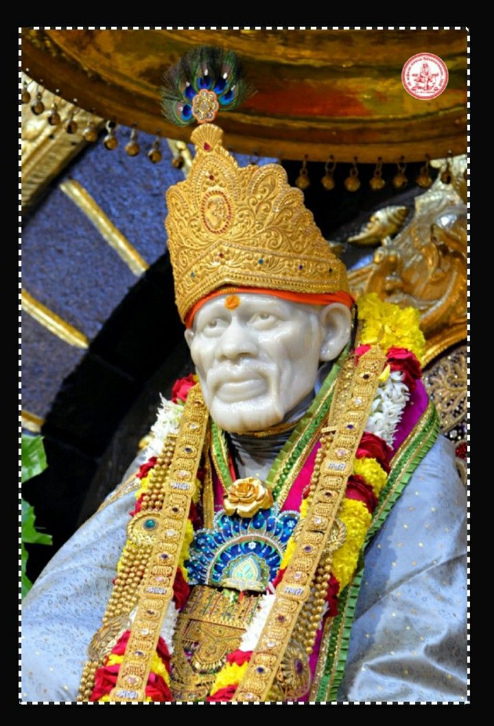 Sai Baba with golden crown and garland.
