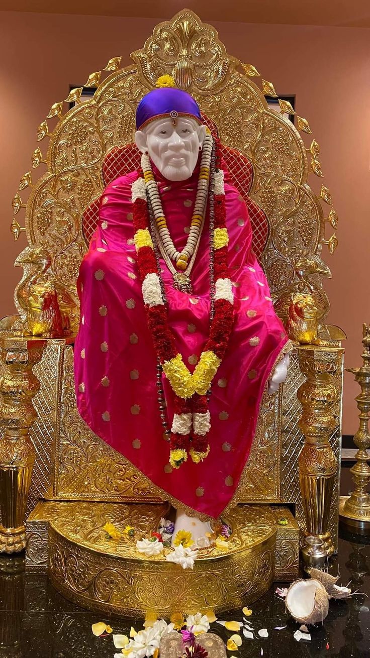 Sai Baba seated on a golden throne