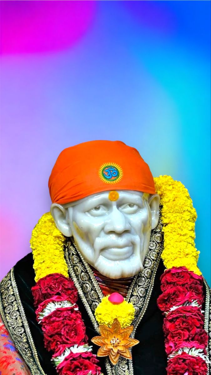 Sai Baba with orange turban and flowers