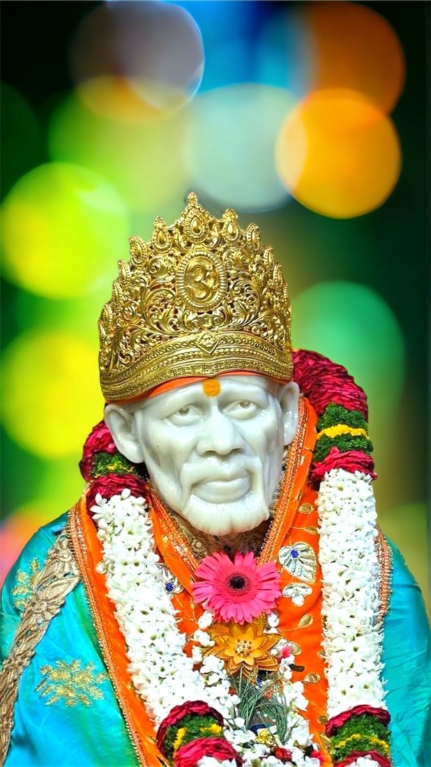 Sai Baba with golden crown and garlands.