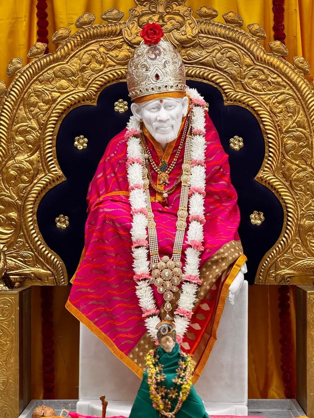 Sai Baba idol with floral garland