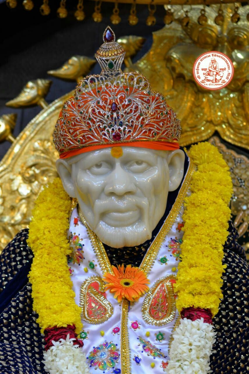 Sai Baba with golden crown and flowers