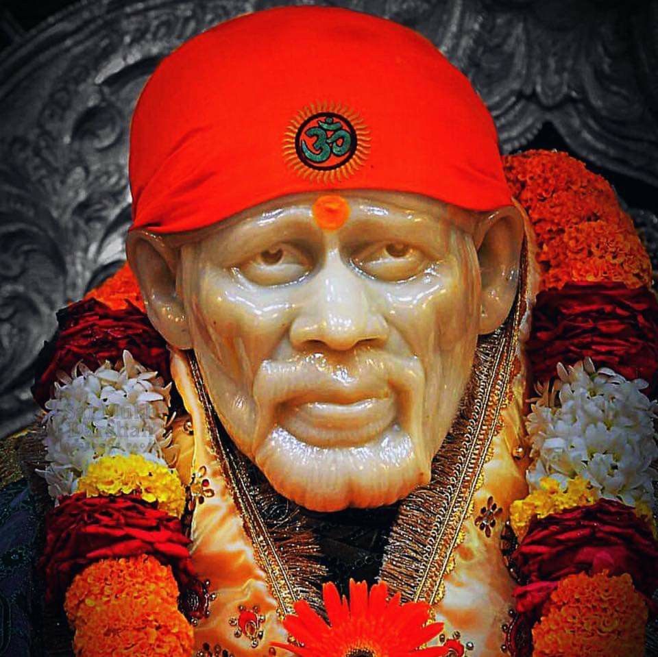 Close-up of Sai Baba with orange turban