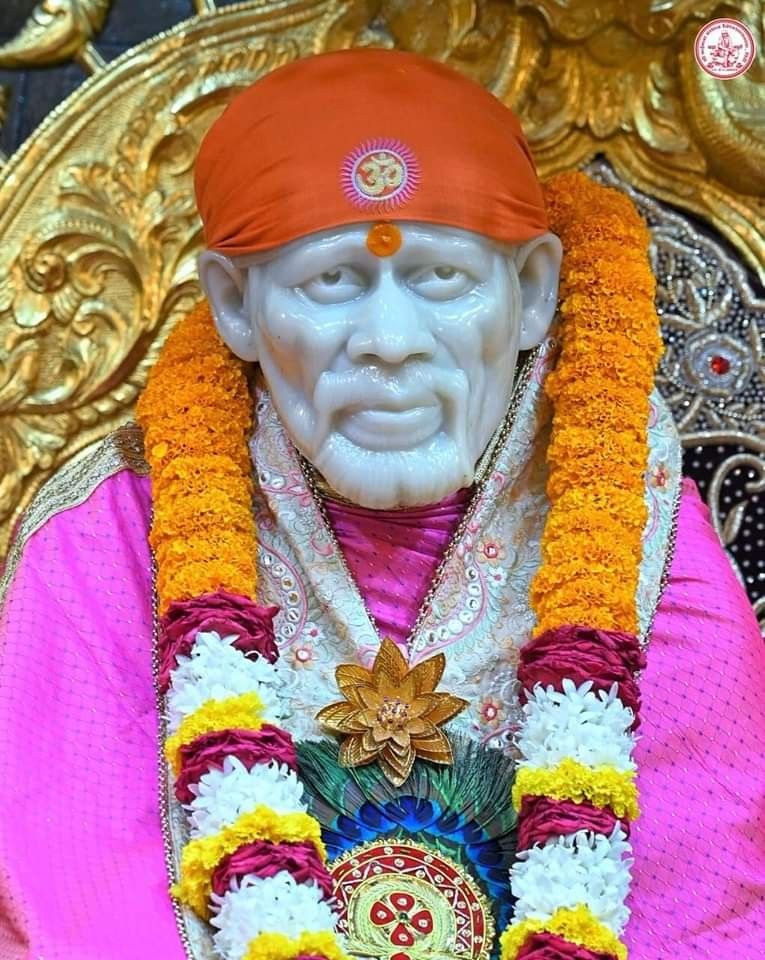 Sai Baba with orange turban and flowers