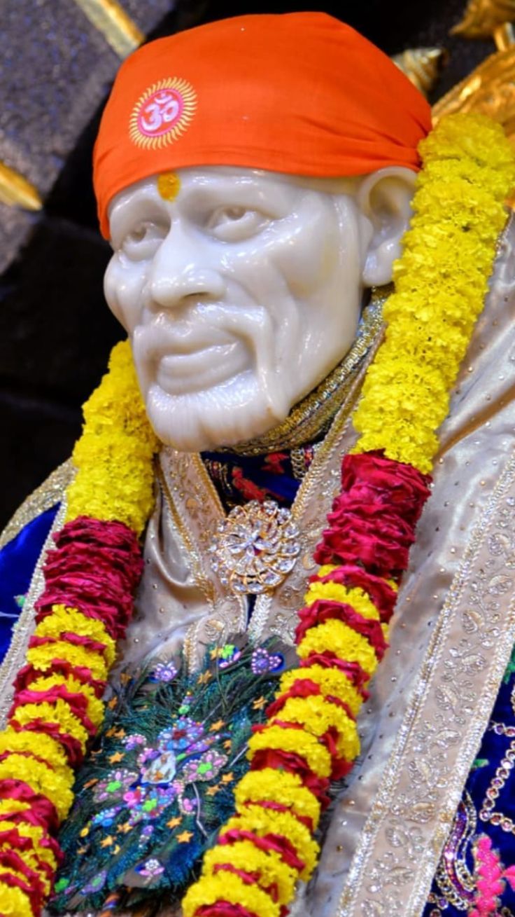 Sai Baba marble statue with garlands