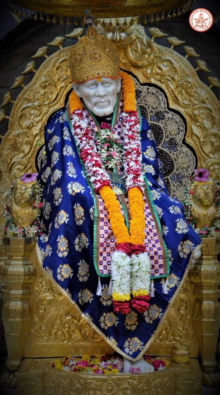 Sai Baba seated on a golden throne