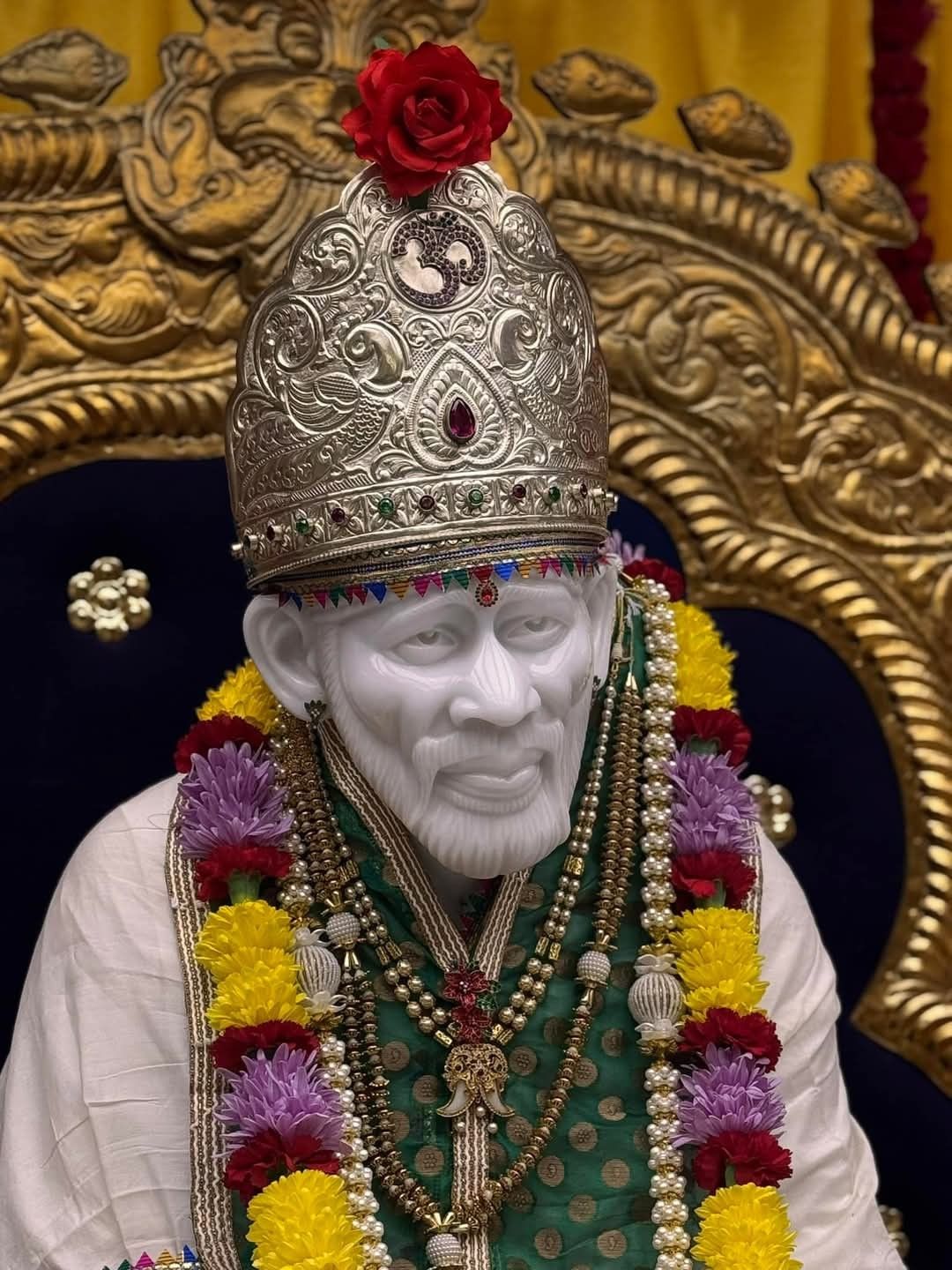 Shirdi Sai Baba idol with flower garland
