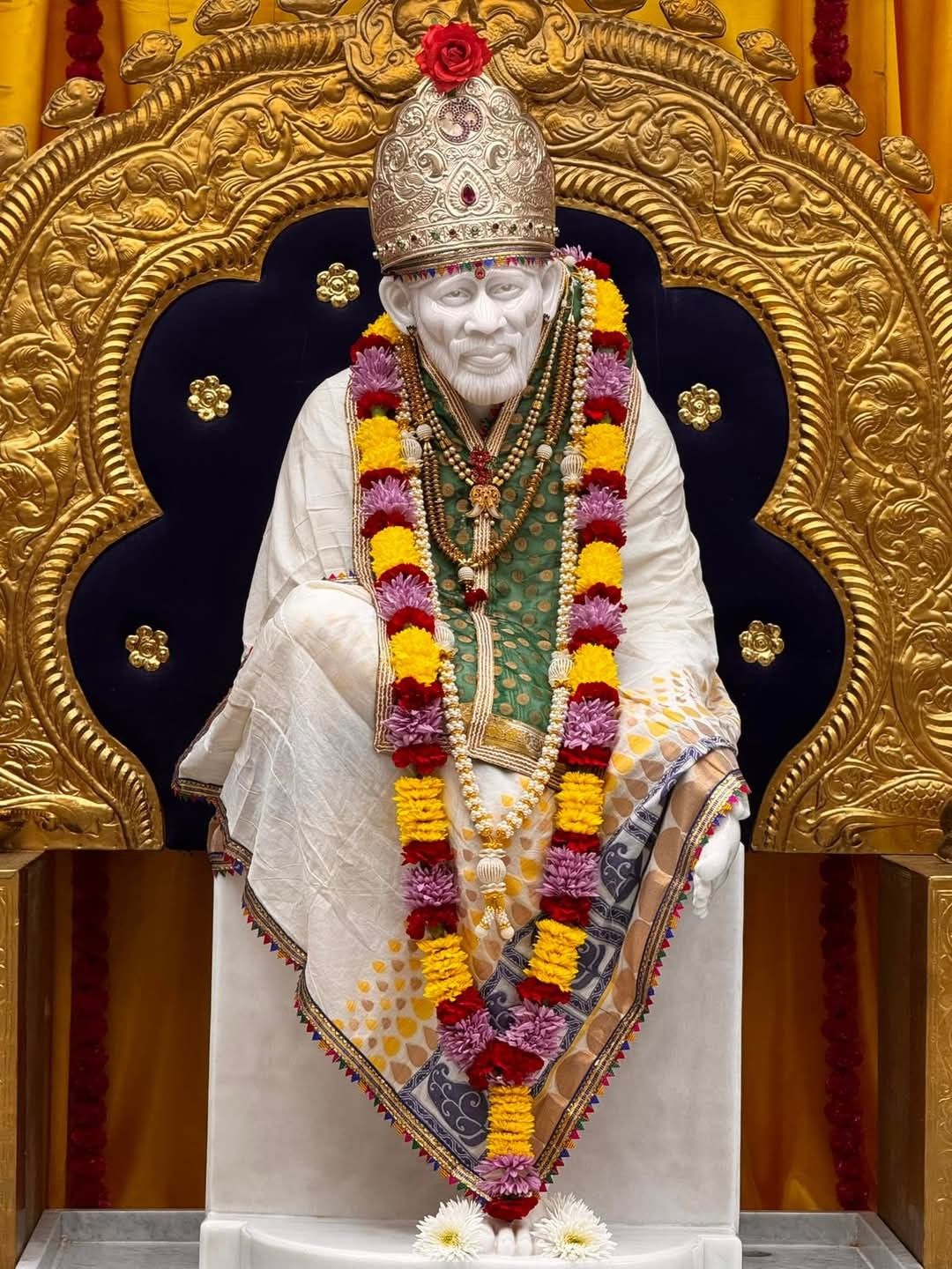Sai Baba statue with floral garland