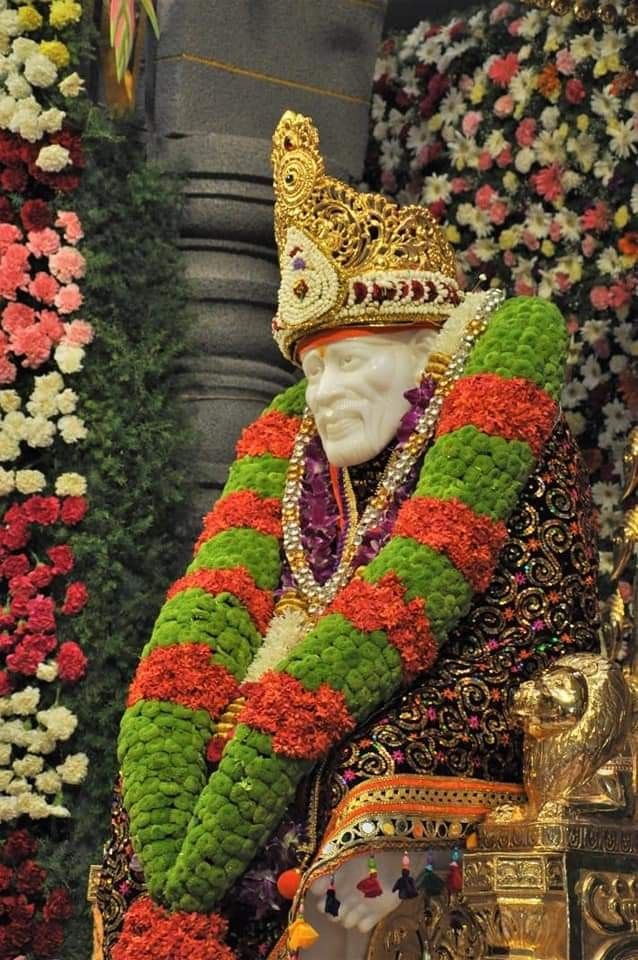 Sai Baba adorned with flower garlands
