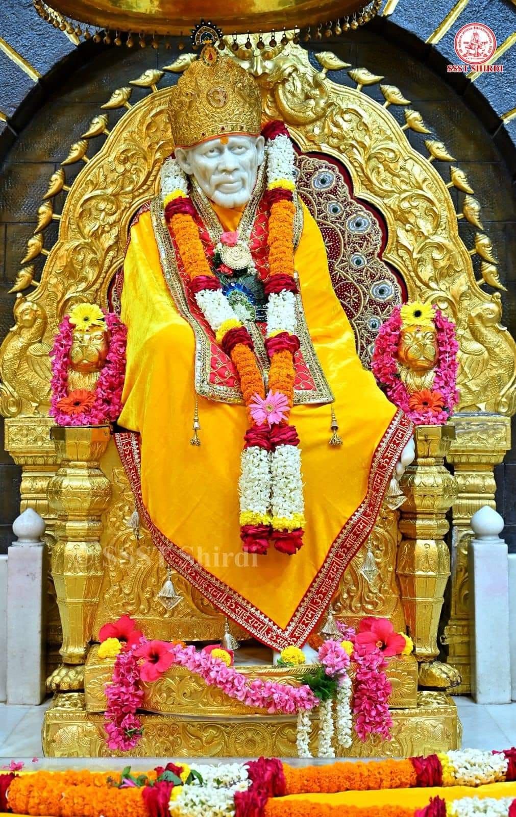 Sai Baba on golden throne.