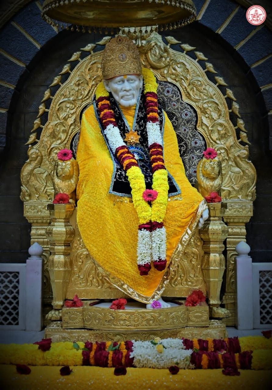 Sai Baba seated on golden throne