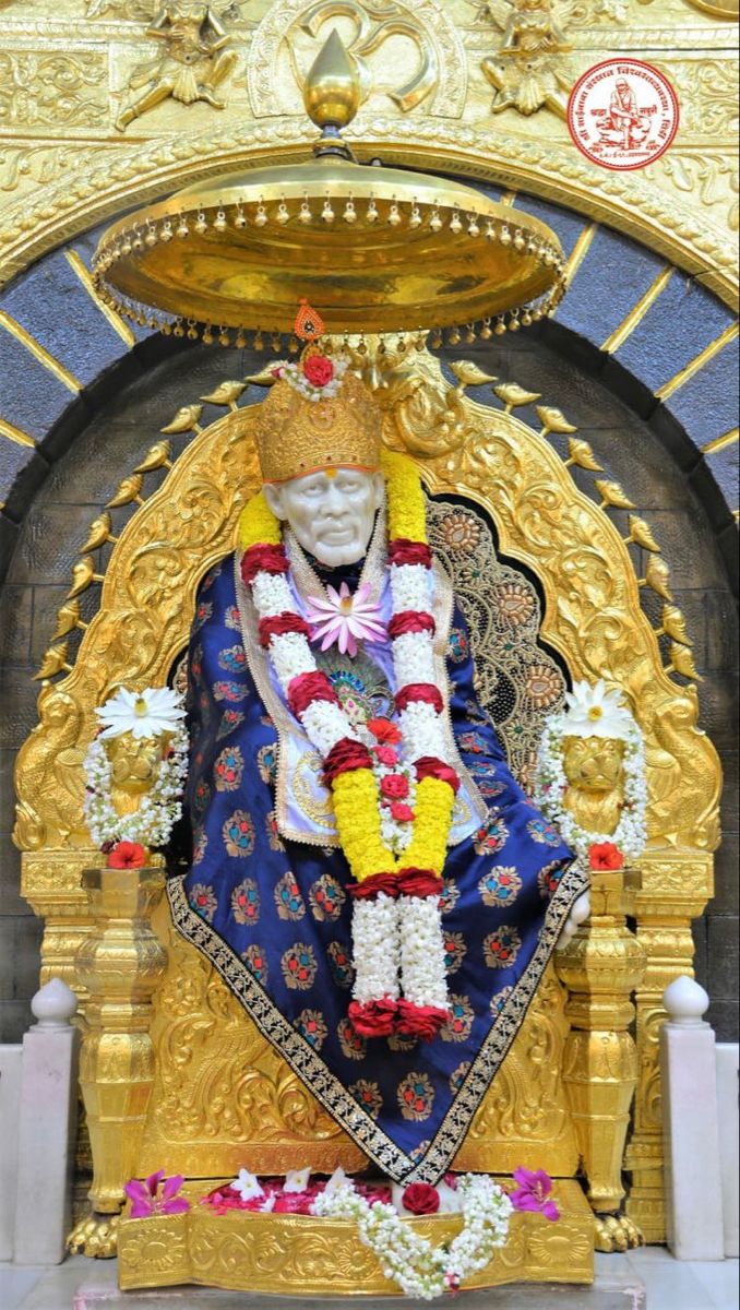 Sai Baba seated on golden throne