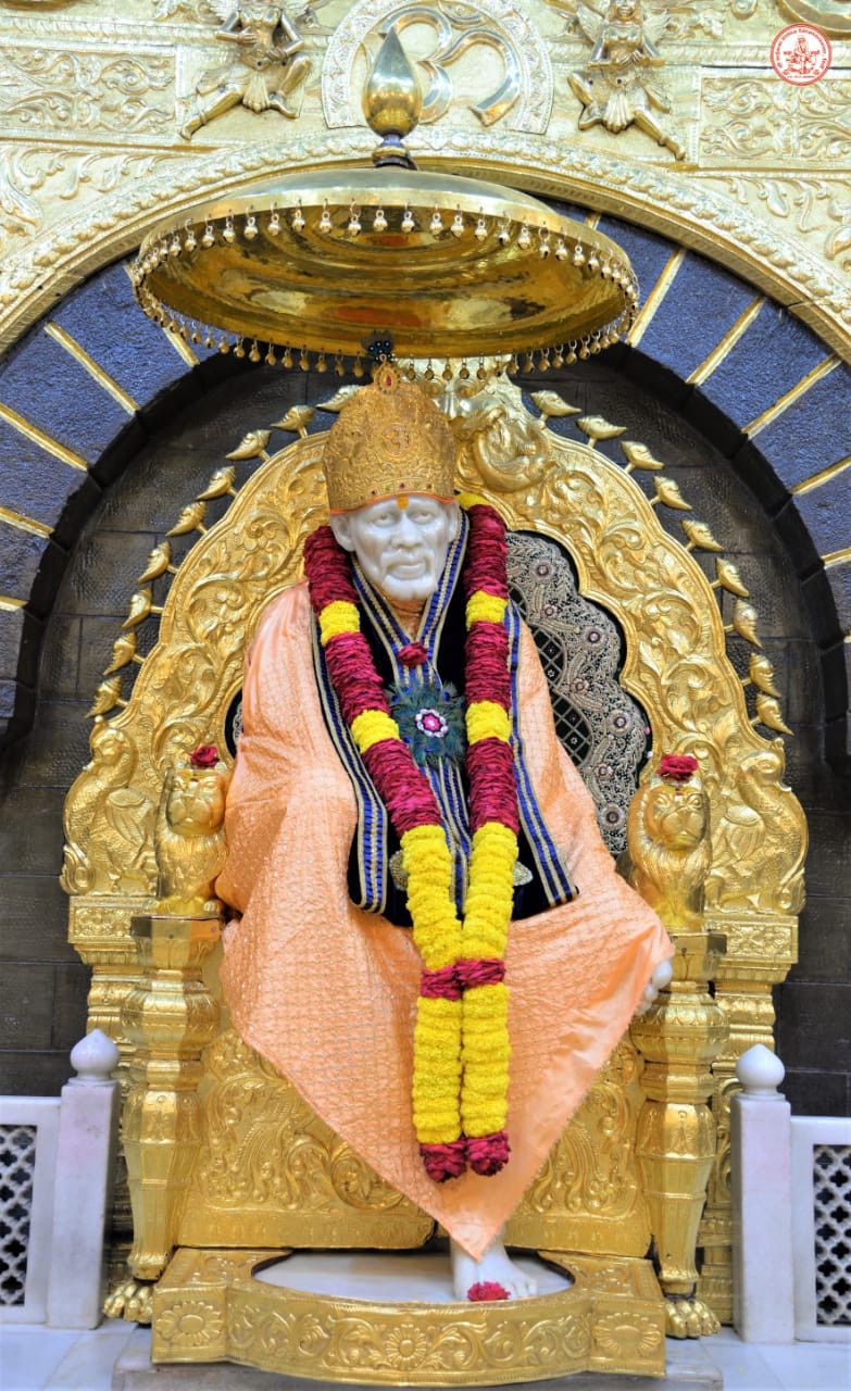 Sai Baba seated on golden throne